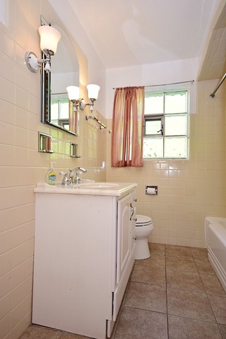 439 Shenstone Road Riverside, IL 60546 - Photo 15 of 25 a bathroom with a sink a toilet and mirror