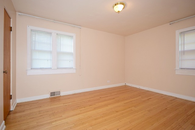 439 Shenstone Road Riverside, IL 60546 - Photo 16 of 25 an empty room with wooden floor and windows