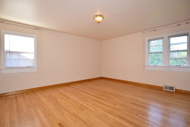 439 Shenstone Road Riverside, IL 60546 - Photo 17 of 25 an empty room with wooden floor and windows