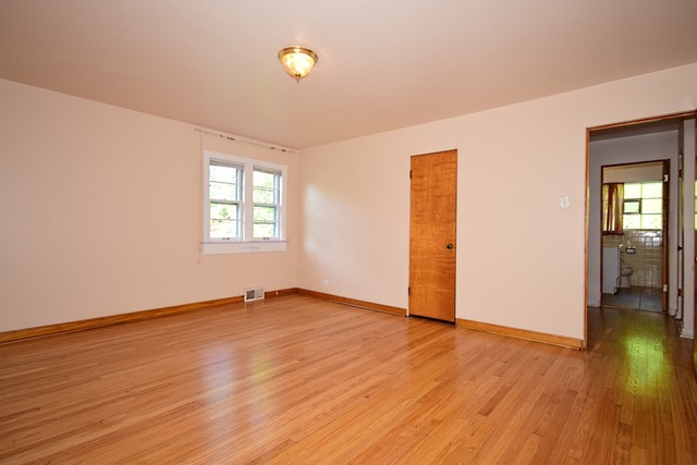 439 Shenstone Road Riverside, IL 60546 - Photo 18 of 25 an empty room with wooden floor and windows