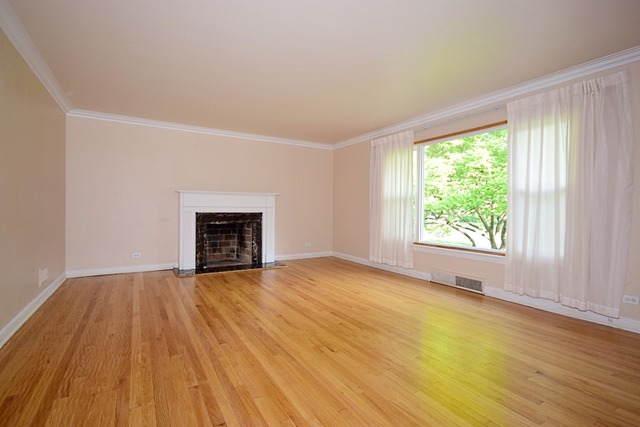 439 Shenstone Road Riverside, IL 60546 - Photo 4 of 25 a view of an empty room with wooden floor and a window