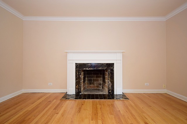 439 Shenstone Road Riverside, IL 60546 - Photo 5 of 25 a view of an empty room with wooden floor and a fireplace