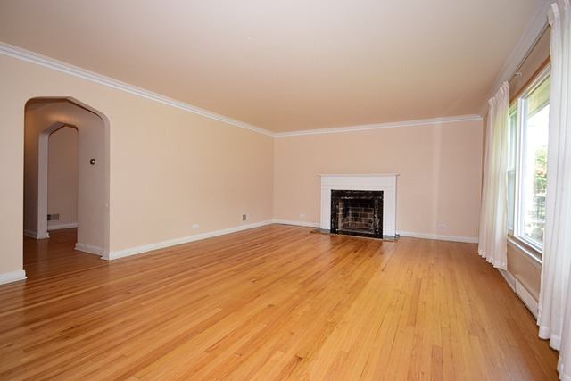439 Shenstone Road Riverside, IL 60546 - Photo 6 of 25 a view of empty room with wooden floor and fireplace