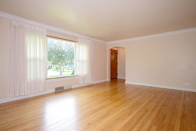 439 Shenstone Road Riverside, IL 60546 - Photo 7 of 25 an empty room with wooden floor and windows