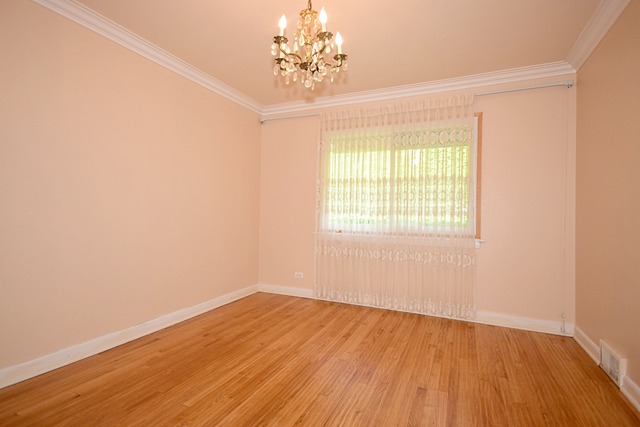 439 Shenstone Road Riverside, IL 60546 - Photo 9 of 25 an empty room with wooden floor and windows
