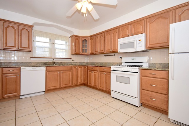 439 Shenstone Road Riverside, IL 60546 - Photo 10 of 25 a kitchen with a stove sink and cabinets