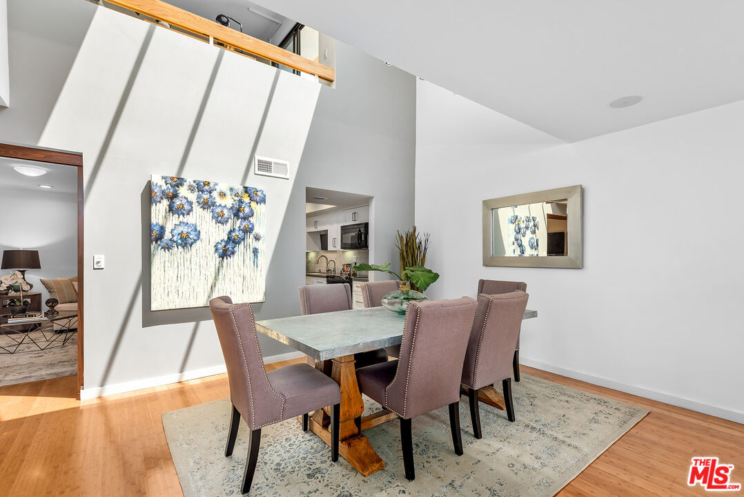 851 North Kings Road, Unit 307 West Hollywood, CA 90069 - Photo 12 of 38 a view of a dining room with furniture and wooden floor