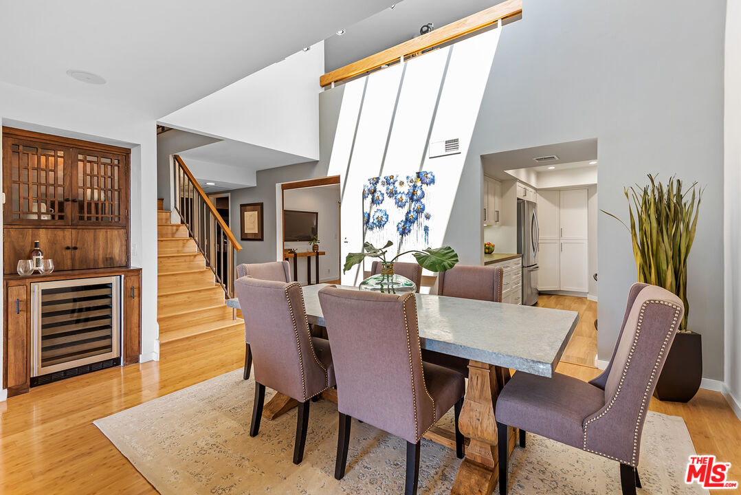 851 North Kings Road, Unit 307 West Hollywood, CA 90069 - Photo 13 of 38 a dining room with furniture and wooden floor