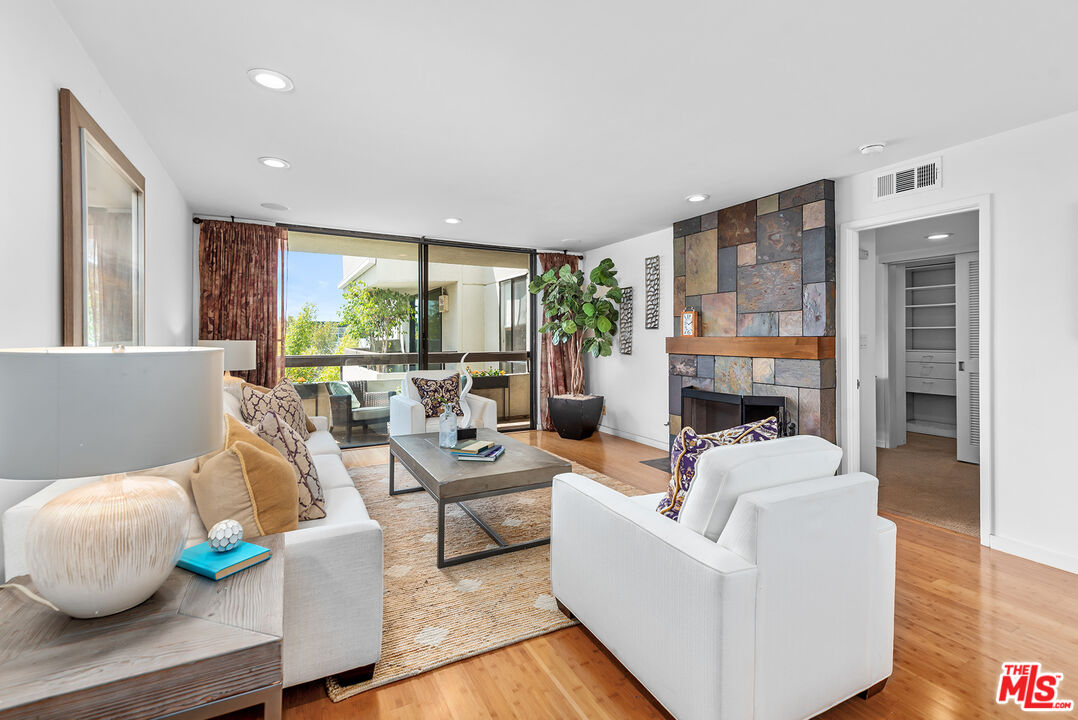 851 North Kings Road, Unit 307 West Hollywood, CA 90069 - Photo 16 of 38 a living room with furniture and a large window