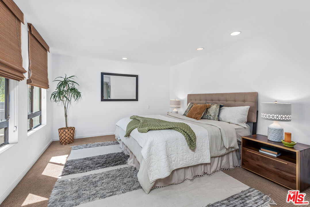 851 North Kings Road, Unit 307 West Hollywood, CA 90069 - Photo 19 of 38 a bedroom with a bed and a couch