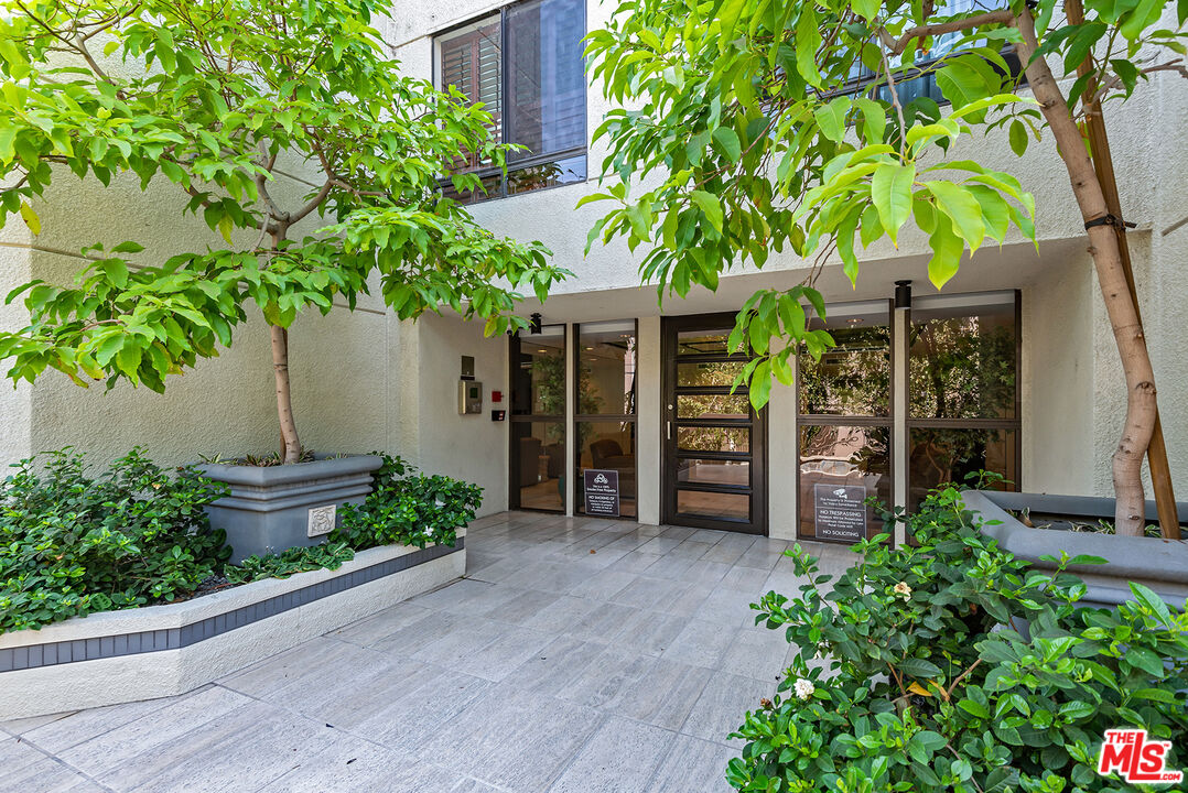 851 North Kings Road, Unit 307 West Hollywood, CA 90069 - Photo 2 of 38 a view of a garden with potted plants