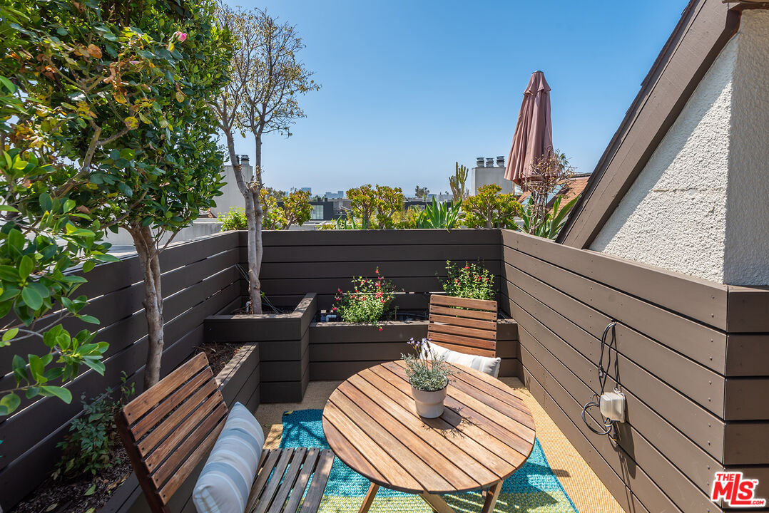 851 North Kings Road, Unit 307 West Hollywood, CA 90069 - Photo 33 of 38 a view of a balcony with two chairs and a potted plant