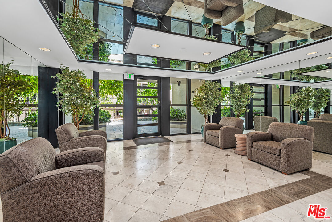 851 North Kings Road, Unit 307 West Hollywood, CA 90069 - Photo 34 of 38 a roof deck with couches and potted plants