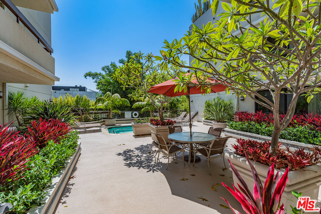 851 North Kings Road, Unit 307 West Hollywood, CA 90069 - Photo 35 of 38 a view of a patio with table and chairs potted plants