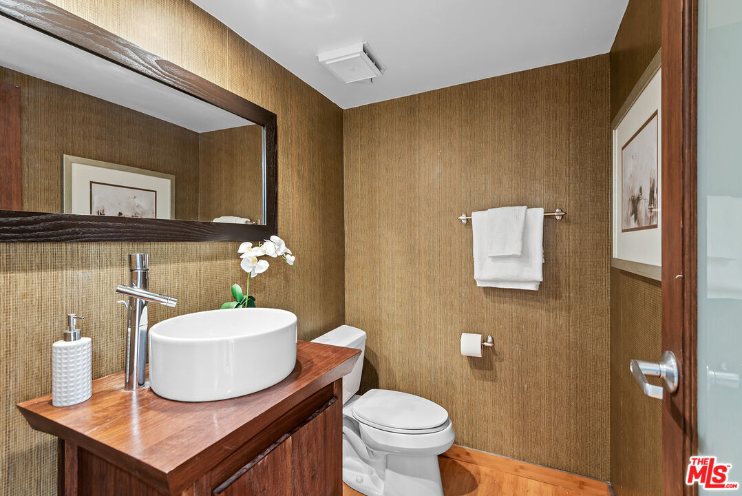 851 North Kings Road, Unit 307 West Hollywood, CA 90069 - Photo 6 of 38 a bathroom with a sink toilet and mirror
