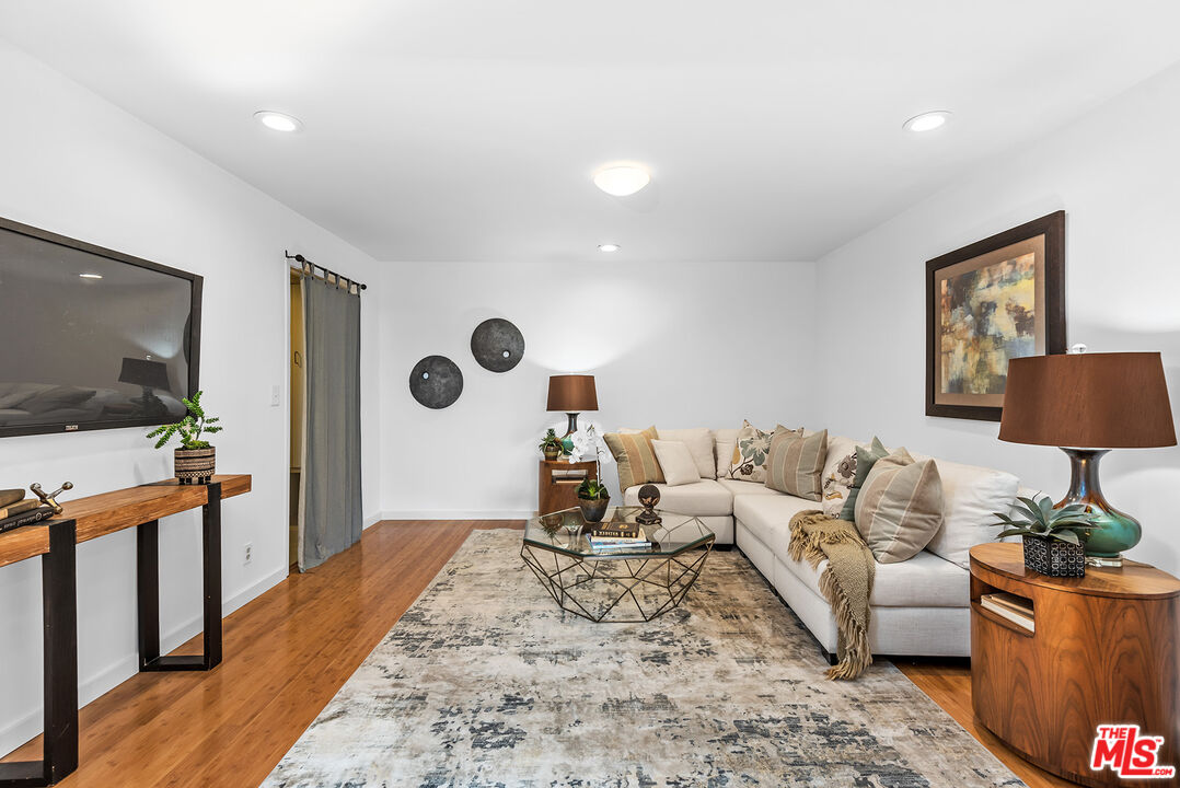851 North Kings Road, Unit 307 West Hollywood, CA 90069 - Photo 7 of 38 a living room with furniture and a flat screen tv