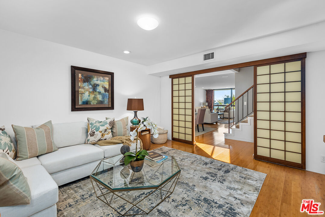 851 North Kings Road, Unit 307 West Hollywood, CA 90069 - Photo 8 of 38 a living room with furniture and wooden floor