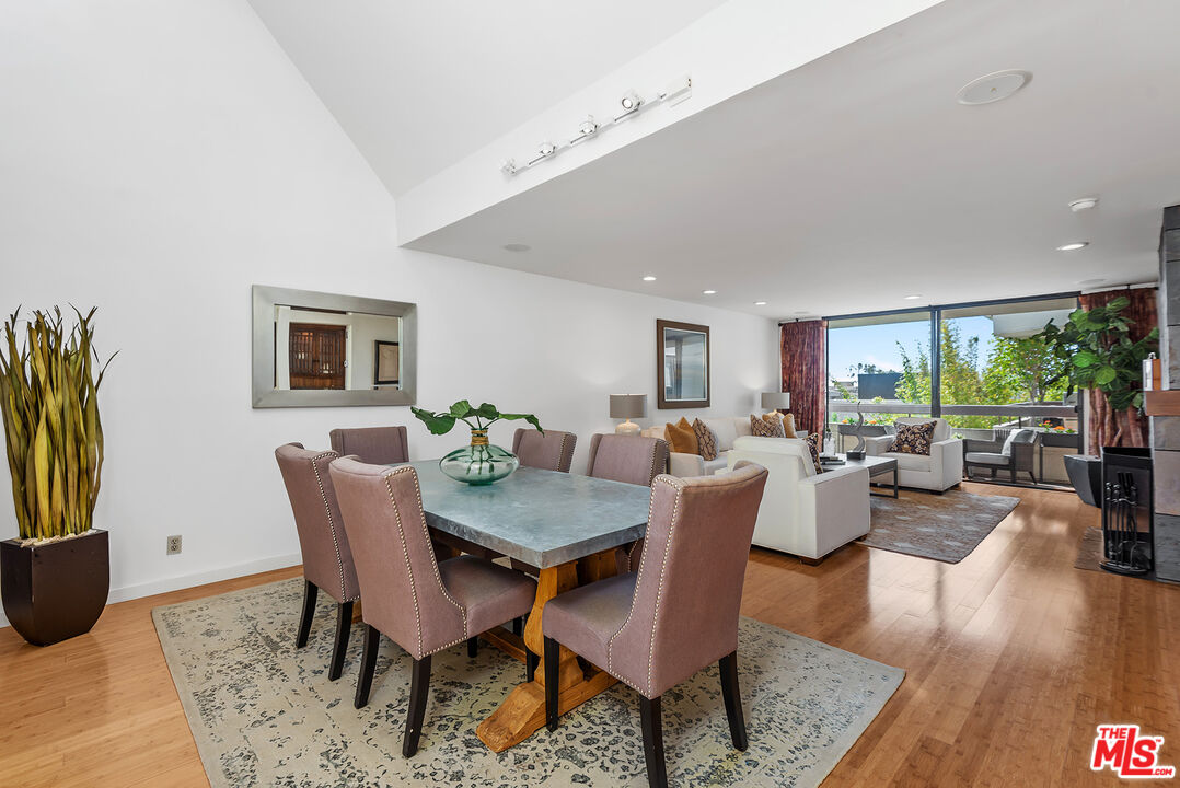 851 North Kings Road, Unit 307 West Hollywood, CA 90069 - Photo 10 of 38 a view of a dining room with furniture and wooden floor
