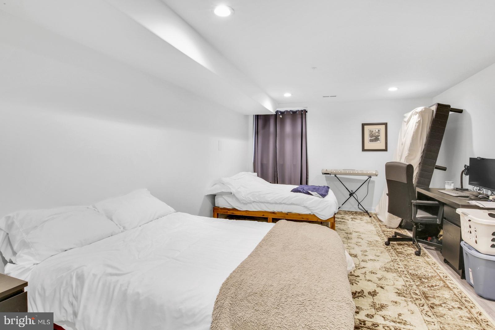 2604 Reed Street Philadelphia, PA 19146 - Photo 11 of 32 a bedroom with a bed a large window and chair