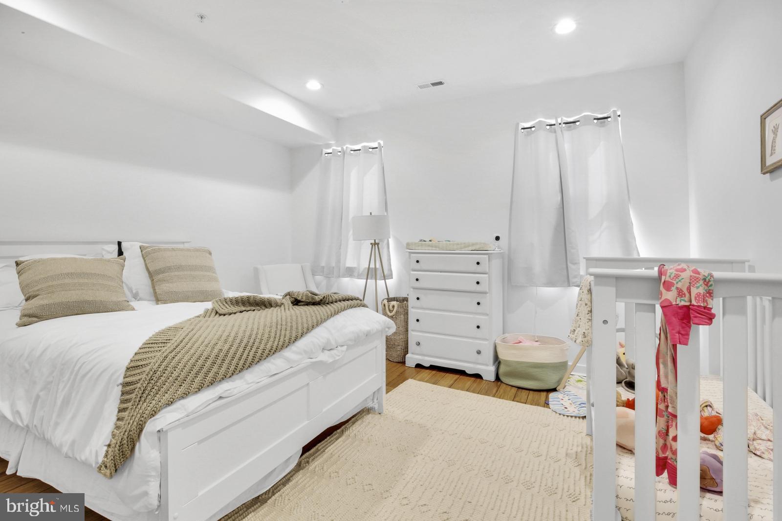 2604 Reed Street Philadelphia, PA 19146 - Photo 13 of 32 a spacious bedroom with a bed and a window
