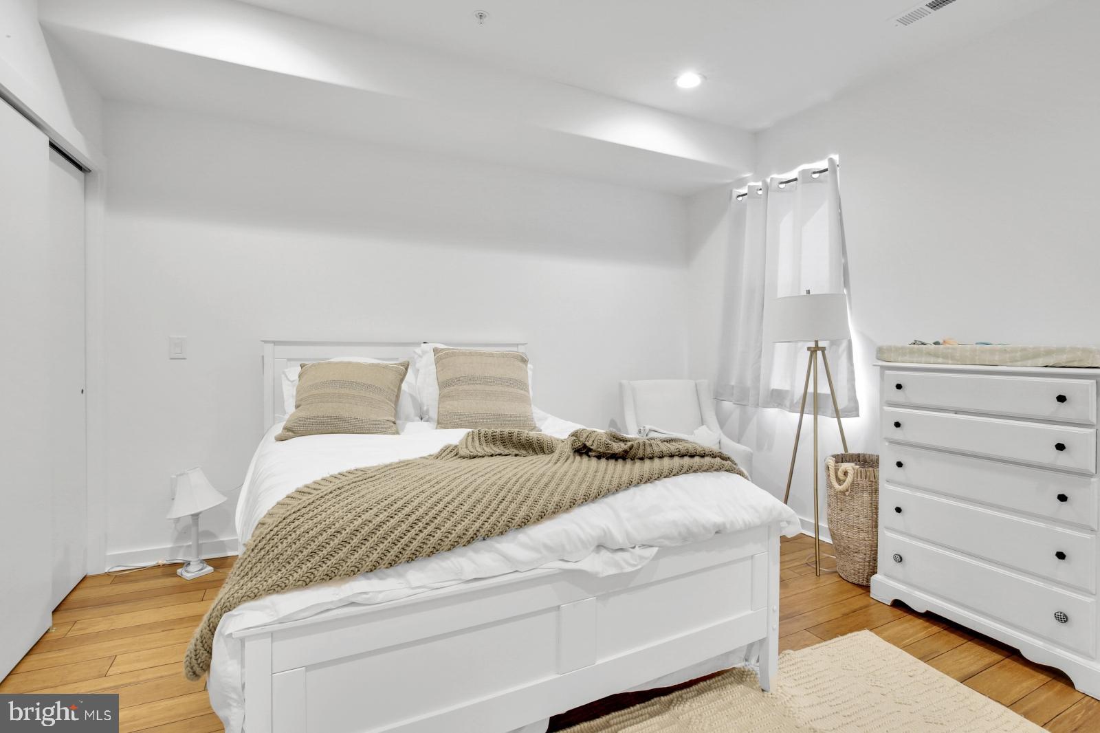 2604 Reed Street Philadelphia, PA 19146 - Photo 14 of 32 a bedroom with a bed and a mirror