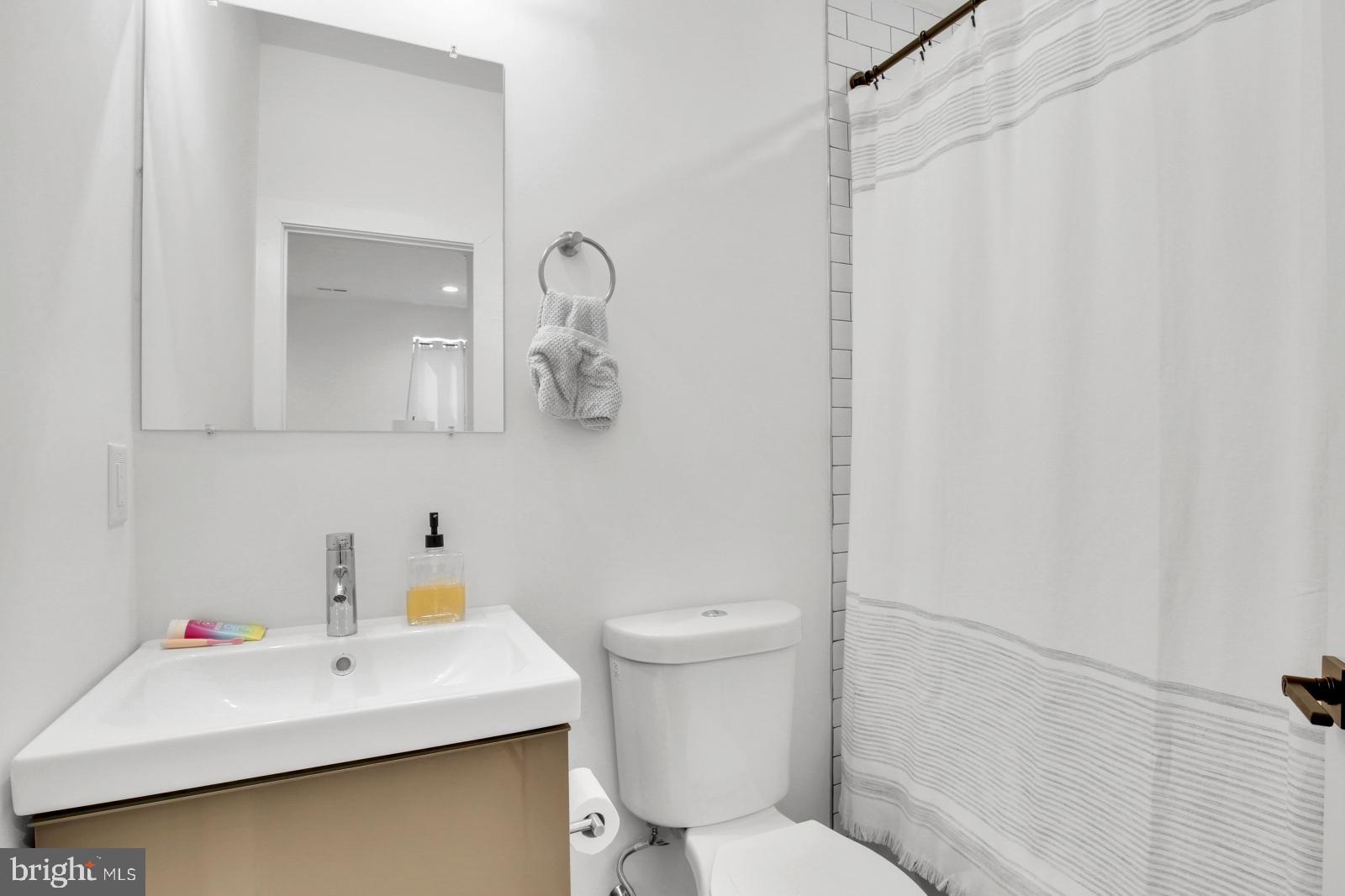 2604 Reed Street Philadelphia, PA 19146 - Photo 16 of 32 a bathroom with a sink mirror and toilet