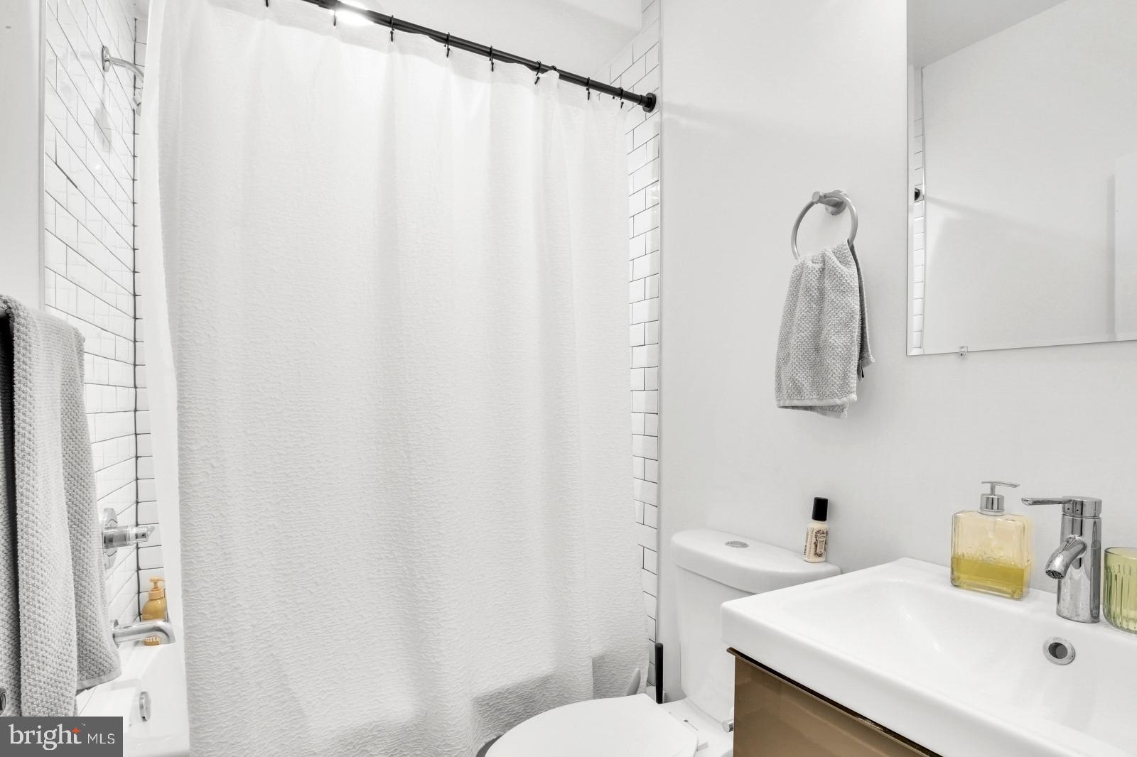 2604 Reed Street Philadelphia, PA 19146 - Photo 17 of 32 a bathroom with a sink and a mirror
