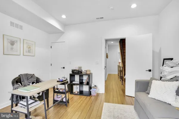 a living room with furniture and wooden floor