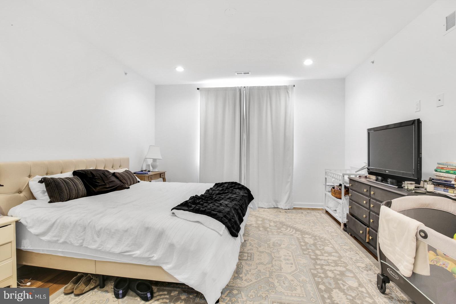 2604 Reed Street Philadelphia, PA 19146 - Photo 22 of 32 a bedroom with a bed and a flat screen tv