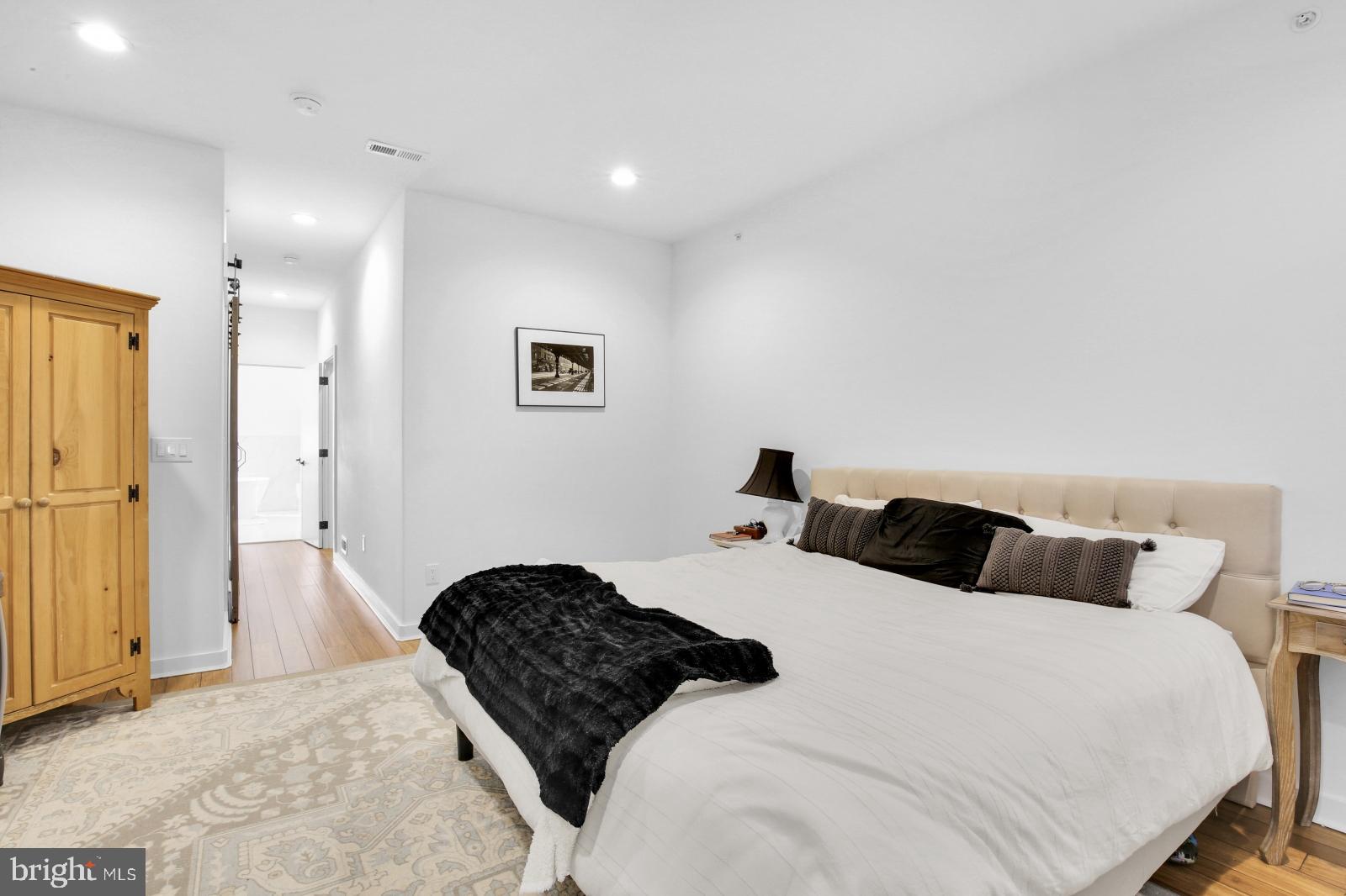 2604 Reed Street Philadelphia, PA 19146 - Photo 23 of 32 a bedroom with a bed and painting on the wall
