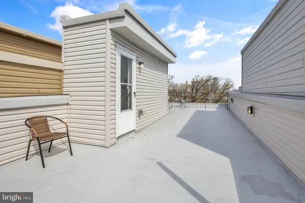 a view of a terrace with chair and white walls