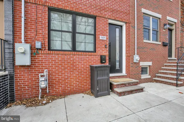 a backyard of a house with a brick wall