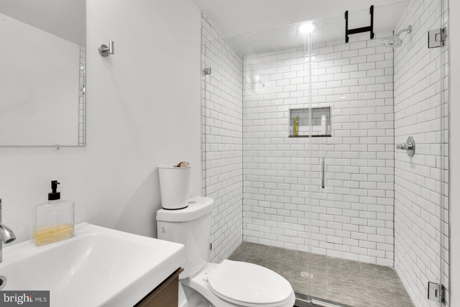 2604 Reed Street Philadelphia, PA 19146 - Photo 9 of 32 a bathroom with a sink a toilet and a mirror
