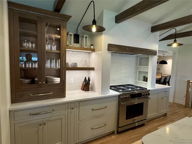 a kitchen with stainless steel appliances granite countertop a stove and a sink