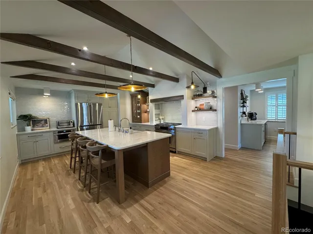 a large kitchen with a table and chairs