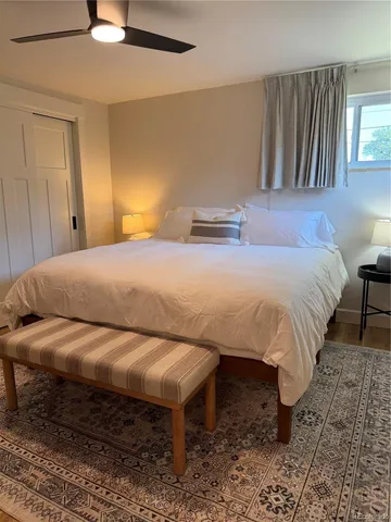 a bathroom with a tub a mirror and shower