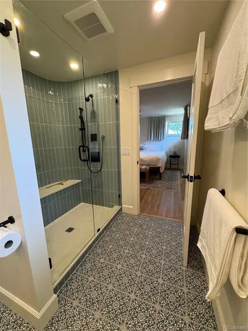 a bathroom with a tub mirror and window