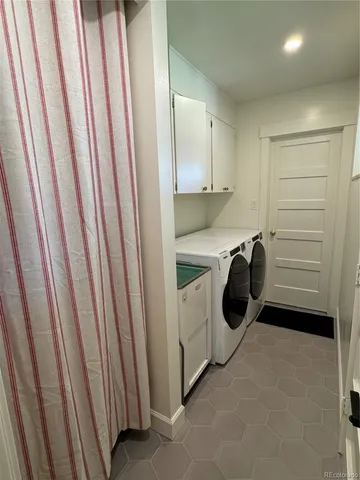 a bathroom with a sink a toilet a mirror and shower