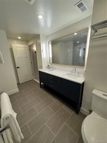a bathroom with a toilet a sink and shower