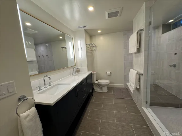 a large bed sitting in a bedroom next to a lamp