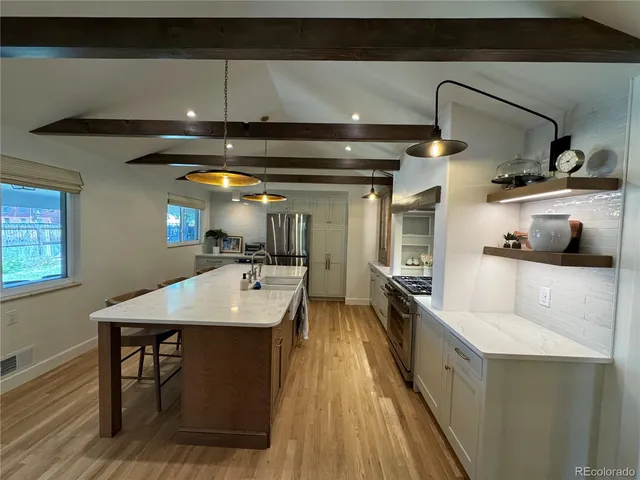 a kitchen with a sink appliances and cabinets