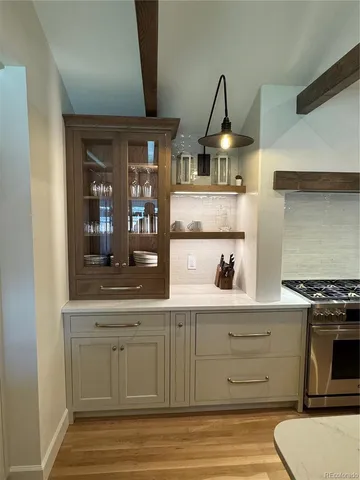 a kitchen with stainless steel appliances granite countertop a stove and a sink
