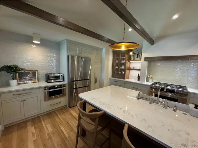 a kitchen with a table chairs sink and stove