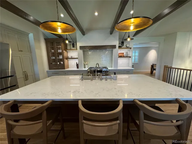 a kitchen with a table chairs and utility room