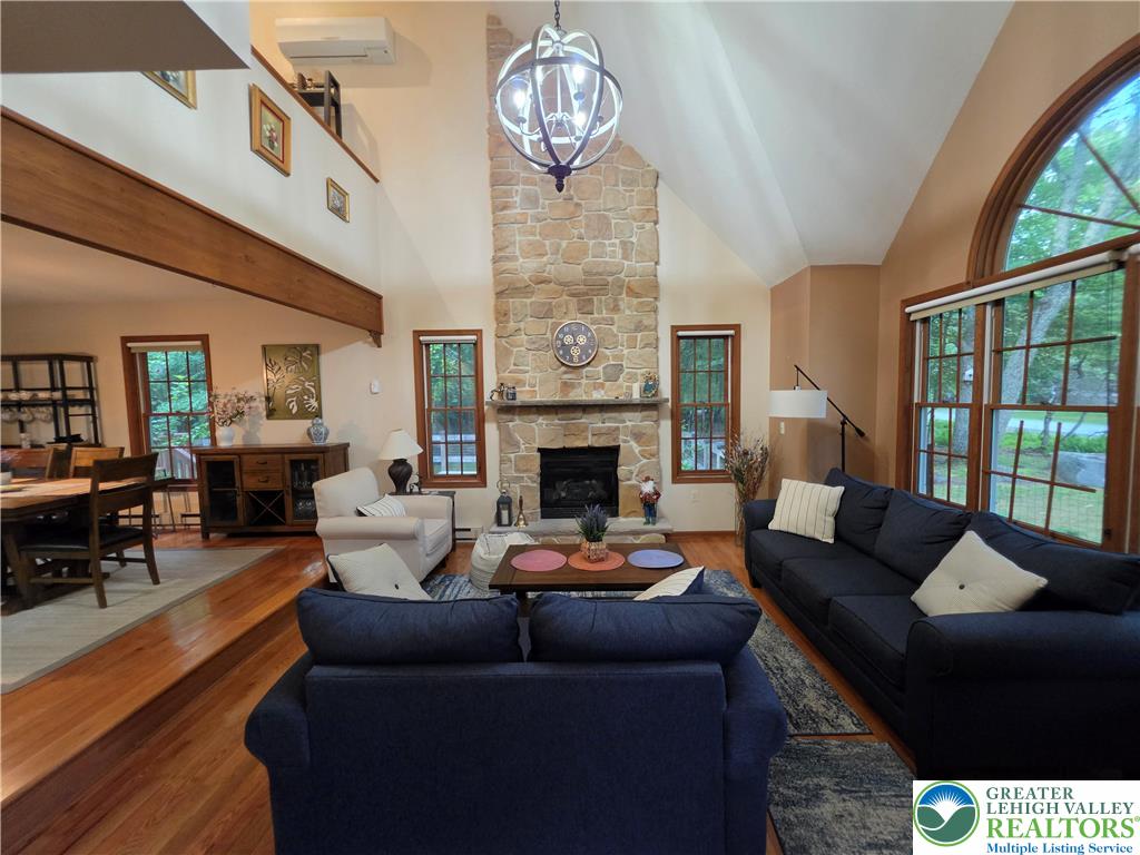 211 Murphy Circle Bushkill, PA 18324 - Photo 3 of 28 A striking stone fireplace anchors this living space, offering warmth and visual appeal.
