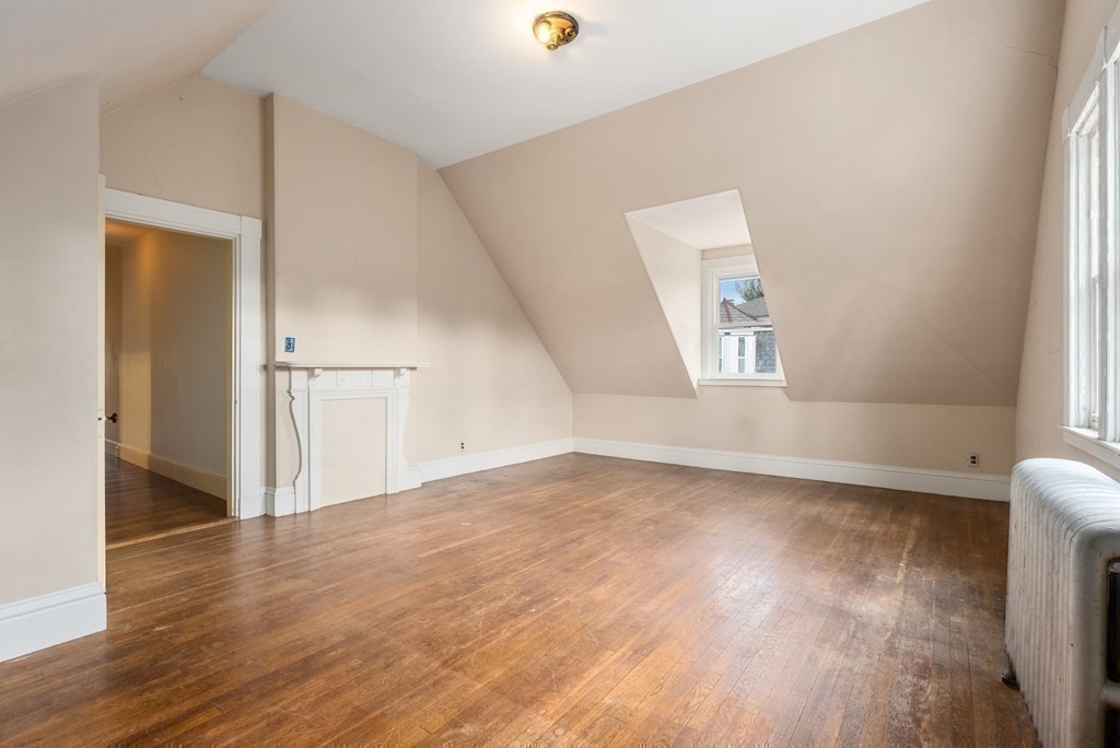 11 Gorham Avenue Brookline, MA 02445 - Photo 16 of 32 an empty room with wooden floor and windows