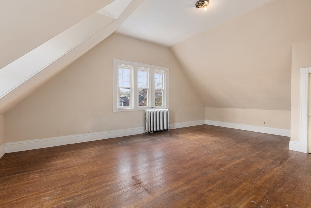 11 Gorham Avenue Brookline, MA 02445 - Photo 17 of 32 an empty room with wooden floor and windows