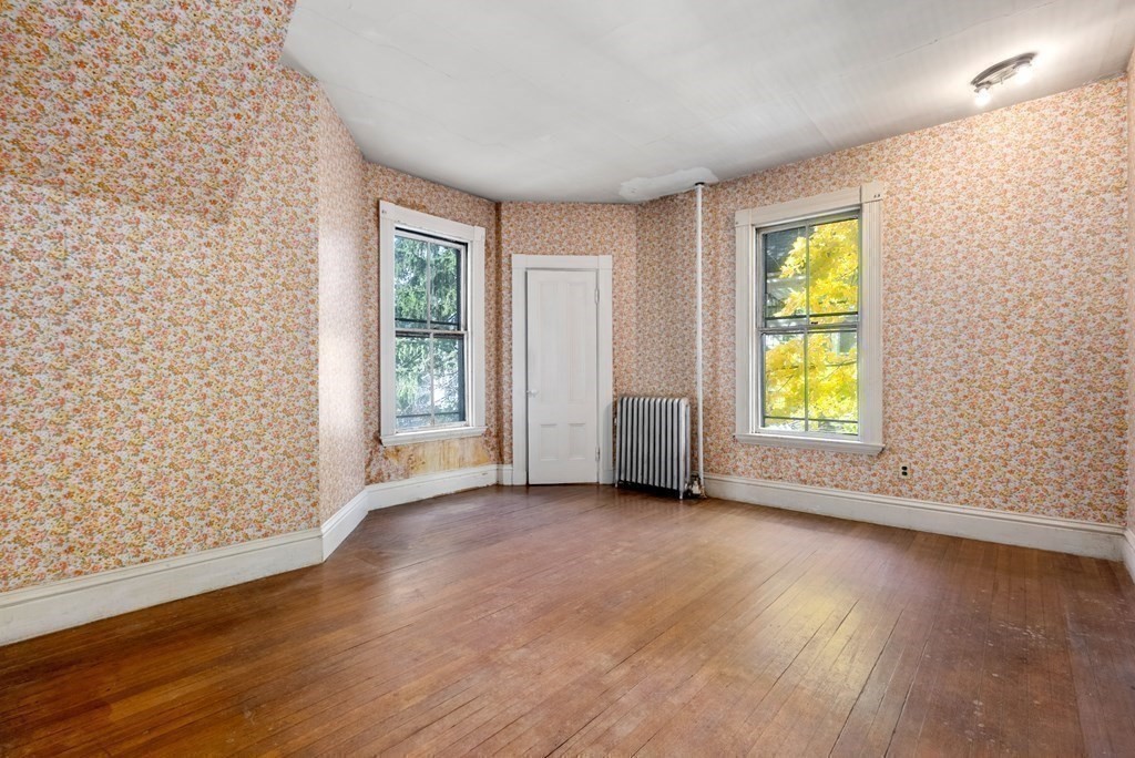 11 Gorham Avenue Brookline, MA 02445 - Photo 22 of 32 an empty room with wooden floor and windows