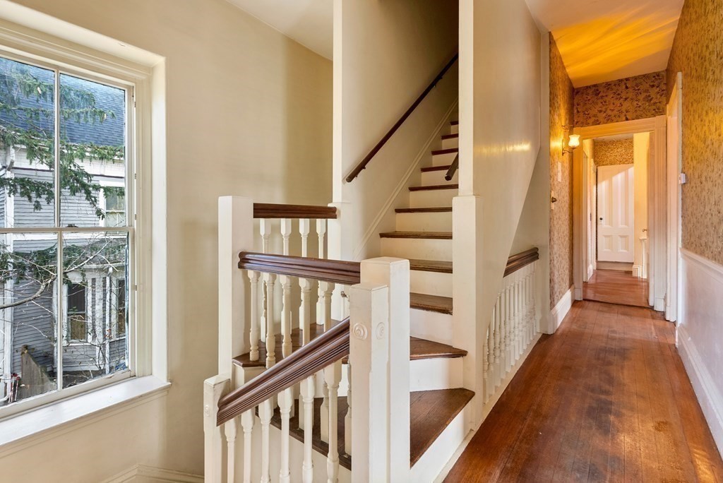 11 Gorham Avenue Brookline, MA 02445 - Photo 6 of 32 a view of staircase with lots of frames on wall and windows