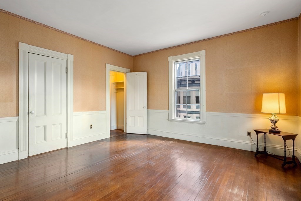 11 Gorham Avenue Brookline, MA 02445 - Photo 8 of 32 wooden floor in an empty room with a window